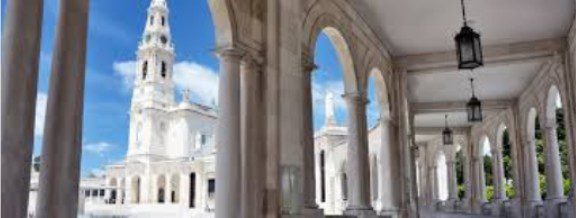White arches and columns under a blue sky.