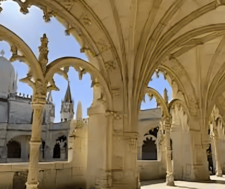 Intricate stone arches frame a historic cathedral under a clear blue sky.