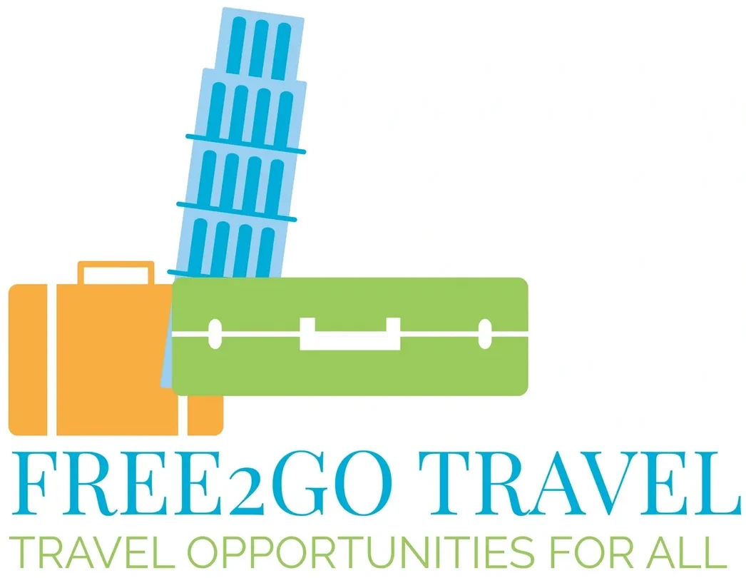 Logo of Free2Go Travel with suitcases and Leaning Tower of Pisa.