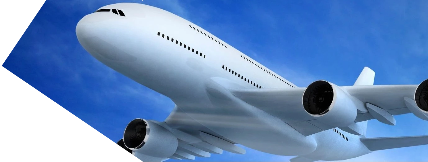 Close-up of a large airplane flying against a clear blue sky.