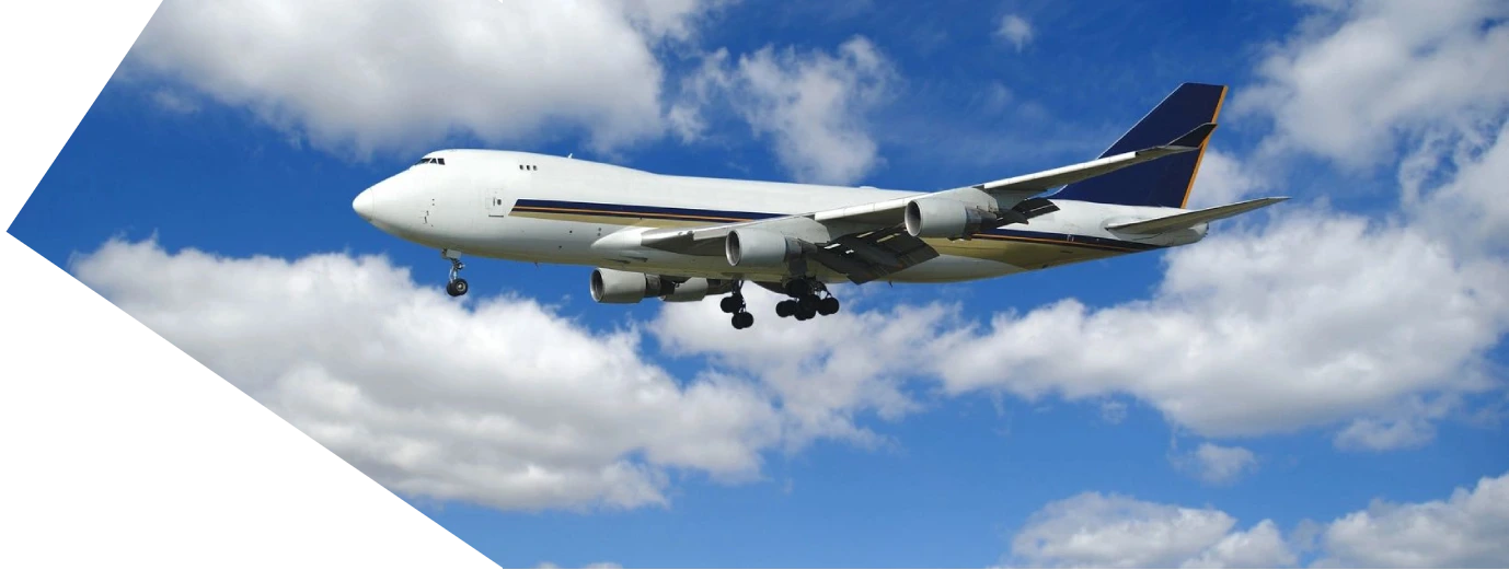 A large commercial airplane flying low over clouds.