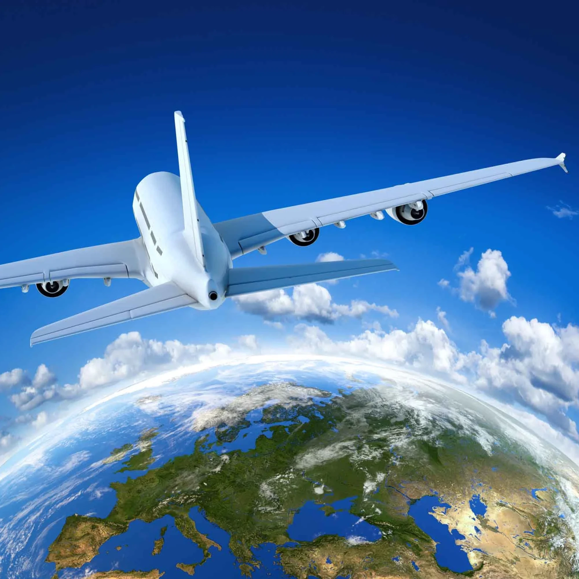 Airplane flying above Earth with blue sky and clouds.