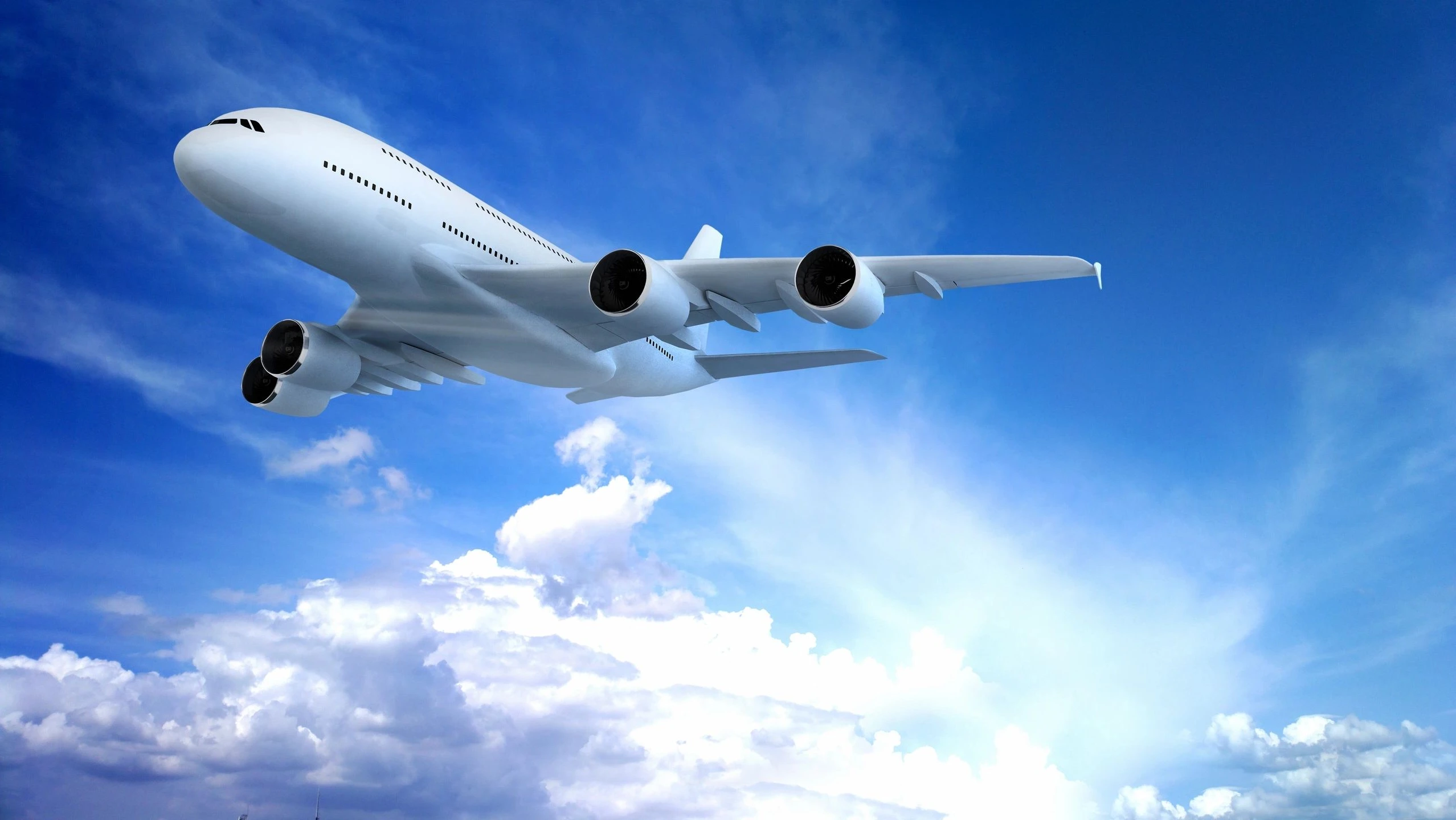 A large airplane flying above the clouds on a clear day.