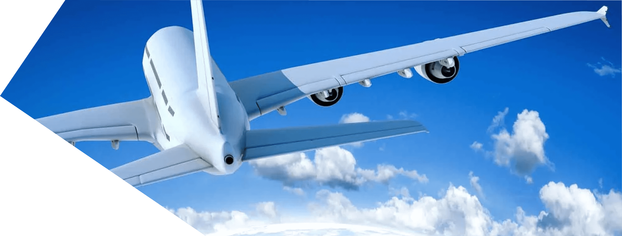 Close-up of an airplane wing and landing gear in flight above clouds.